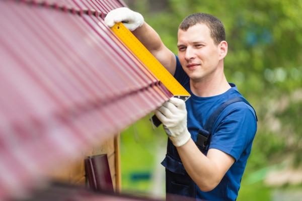 Man-measuring-roofing-details