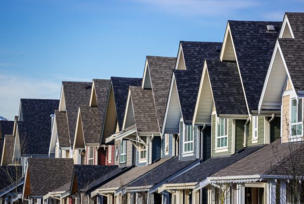 Row of modern townhouses with slightly different roof colours.