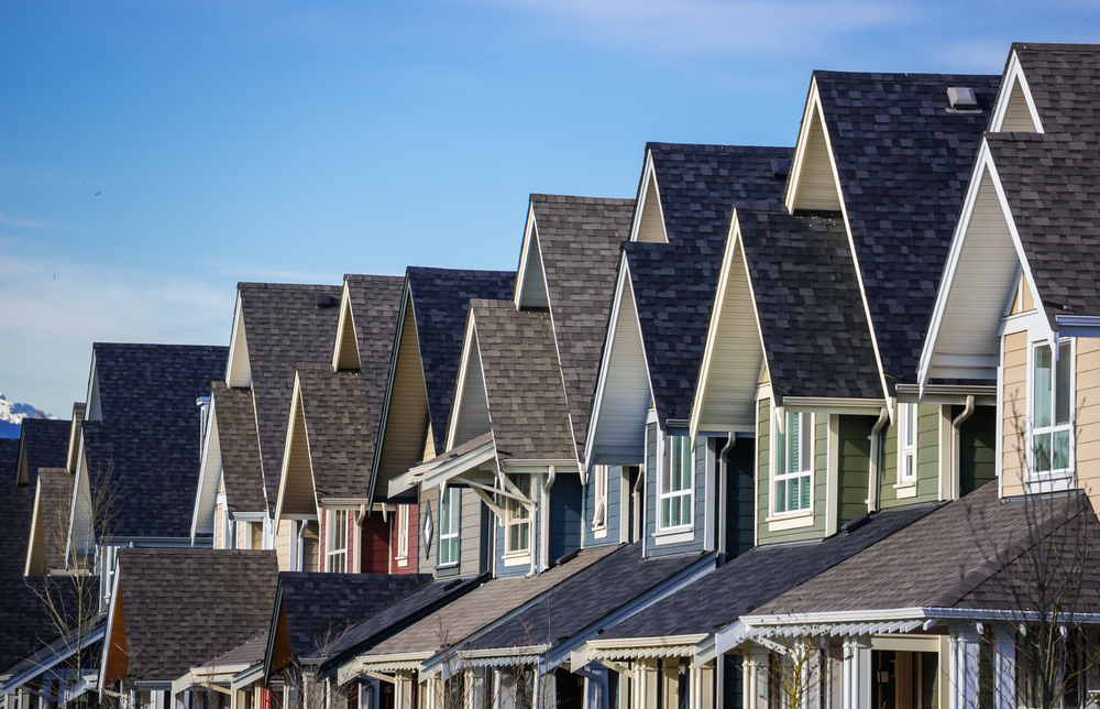 Row of modern townhouses with slightly different roof colours.